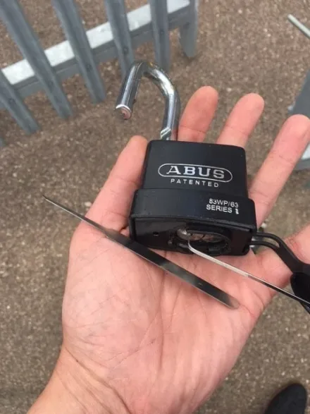 ABUS 83WP/63 padlock picked open at a palisade security gate