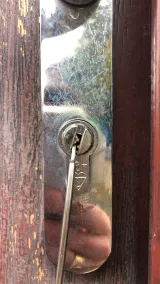 Locksmith picking a three-star anti-snap euro cylinder on a timber front door