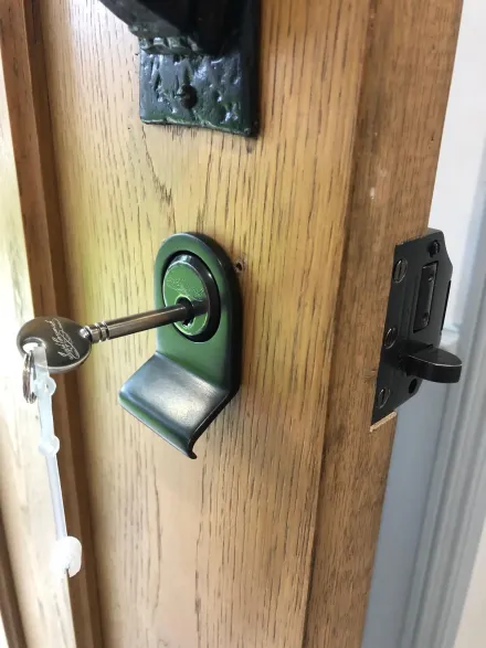 Joseph Bramah cylinder pull and key fitted to an oak front door in Amersham alongside a black rim deadlock