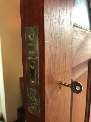 Union five-lever BS3621 mortice deadlock faceplate with brass key in a mahogany door