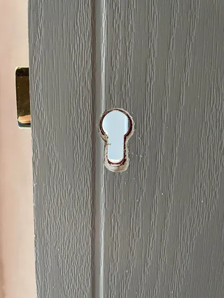 Fresh euro-cylinder cutout in a grey composite door before the new lock goes in