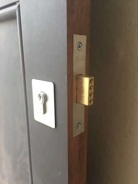Brass five-lever mortice deadlock in the edge of a timber door