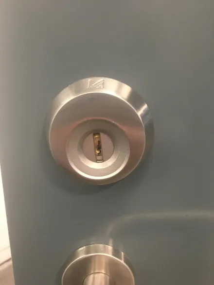 MICO stainless cylinder guard protecting a euro cylinder on a commercial door