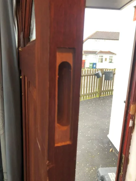 Freshly routed mortice lock pocket in a dark composite door opening to the street