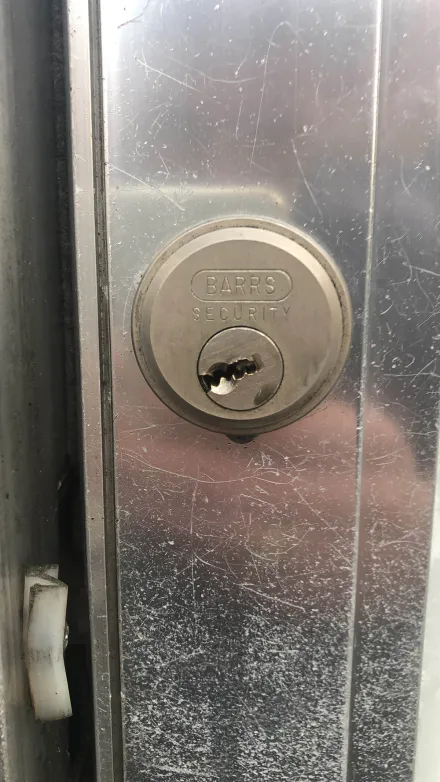 BARRS Security rim cylinder on an aluminium shopfront door