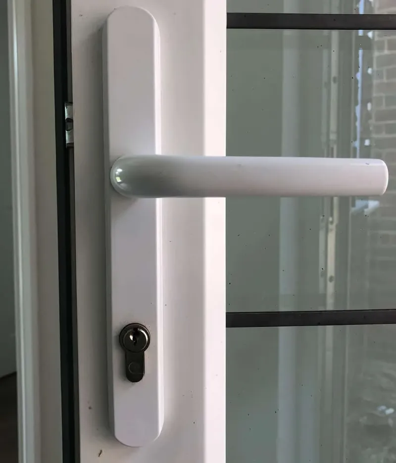 White long-plate handle and euro cylinder on a glazed uPVC door