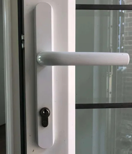 White long-plate handle and euro cylinder on a glazed uPVC door